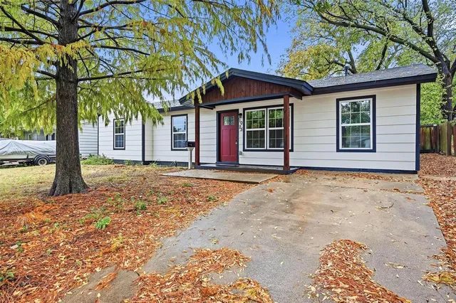 front view of a house with a large tree