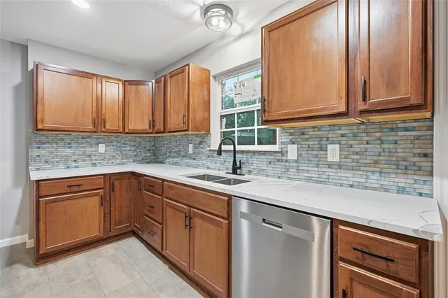 a kitchen with stainless steel appliances granite countertop a sink and cabinets
