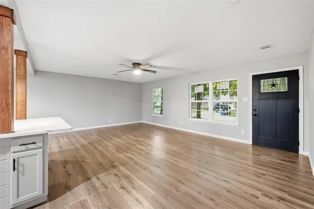 wooden floor in an empty room with a window