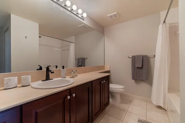 a bathroom with a double vanity sink and a toilet