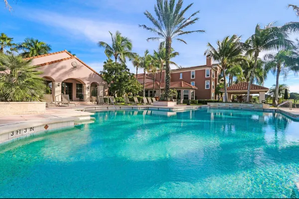 a swimming pool with outdoor seating and yard