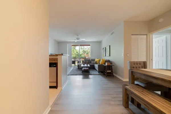 a living room with furniture and a wooden floor