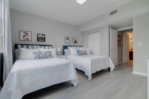 a bedroom with a bed and a night stand