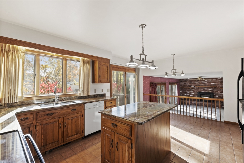43 Maple Road Westford, MA 01886 - Photo 12 of 31 a kitchen with stainless steel appliances granite countertop a sink a stove and wooden floors