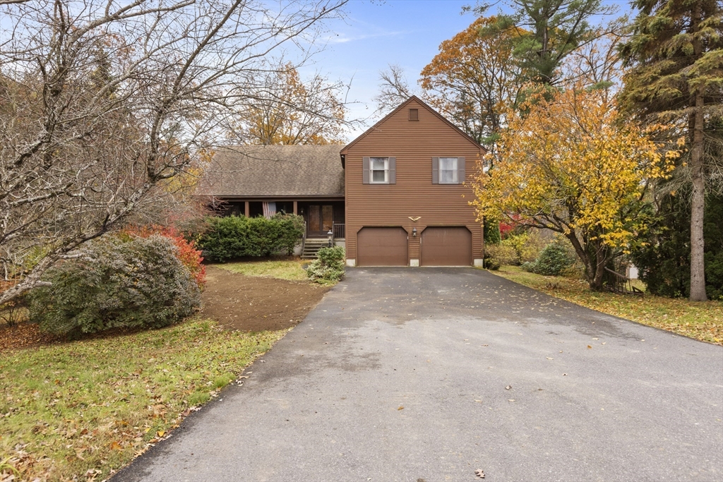 43 Maple Road Westford, MA 01886 - Photo 31 of 31 a front view of a house with a yard and garage