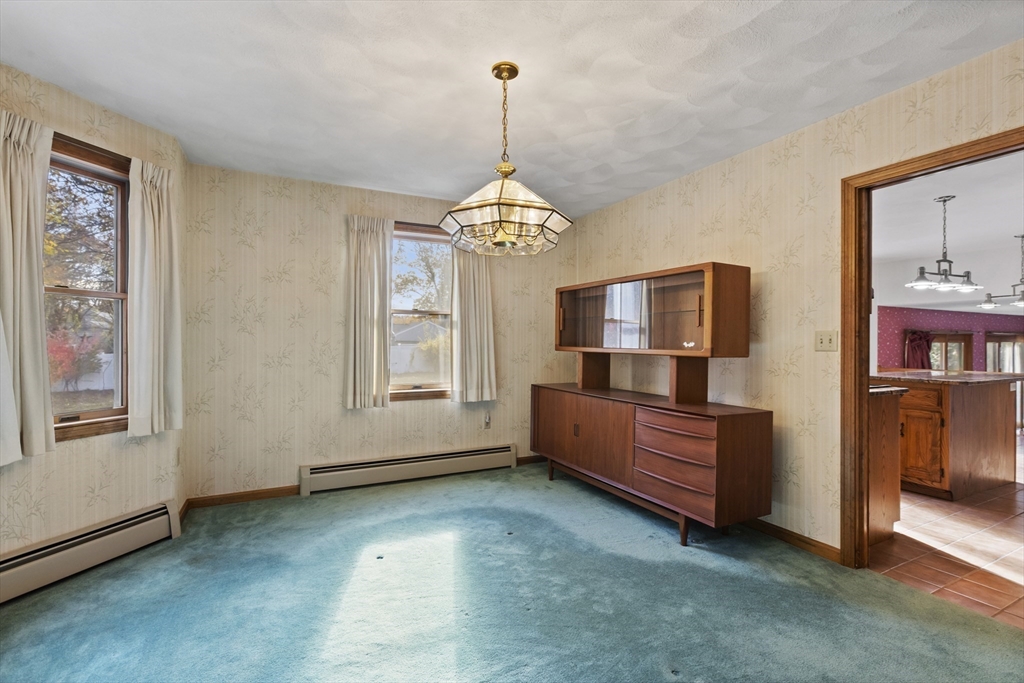 43 Maple Road Westford, MA 01886 - Photo 8 of 31 a living room with furniture and a chandelier