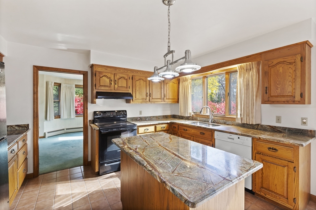 43 Maple Road Westford, MA 01886 - Photo 9 of 31 a kitchen with stainless steel appliances granite countertop a sink stove and refrigerator