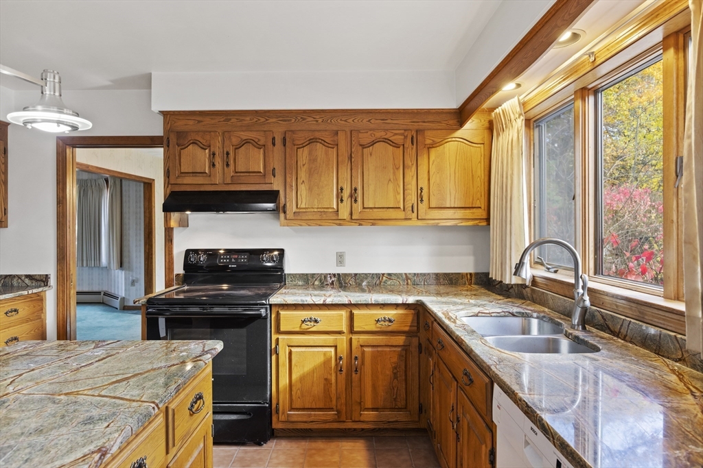 43 Maple Road Westford, MA 01886 - Photo 10 of 31 a kitchen with granite countertop a sink a counter top space cabinets and stainless steel appliances