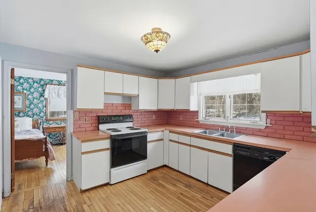 a kitchen with a stove a sink and a refrigerator