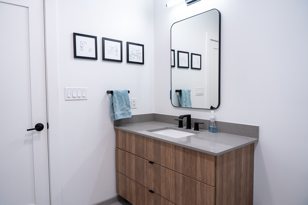 2 Sinclair Road, Unit 202 Boston, MA 02134 - Photo 15 of 23 a bathroom with a sink and a mirror