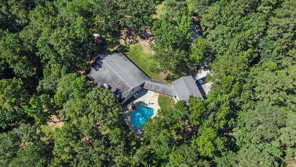 an aerial view of a house with yard and outdoor seating