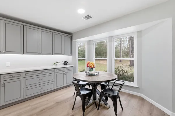 a kitchen with a table and chairs in it