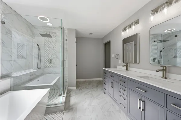 a bathroom with a double vanity sink mirror double and bathtub