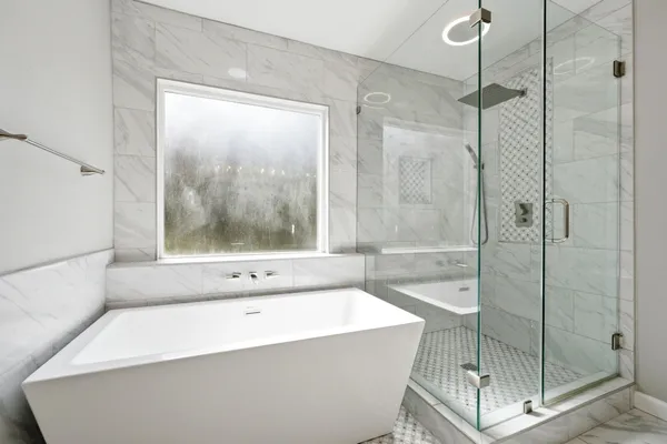 a bathroom with a bathtub and shower