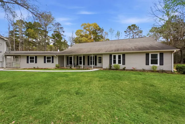 a view of a house with a backyard