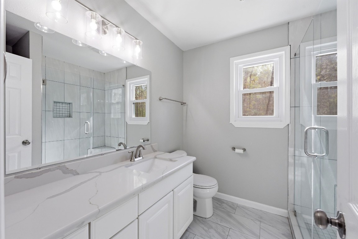 5222 Ranch Hill Drive Magnolia, TX 77354 - Photo 20 of 41 a bathroom with a granite countertop sink toilet and shower