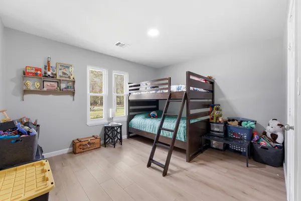 a bedroom with furniture and a wooden floor
