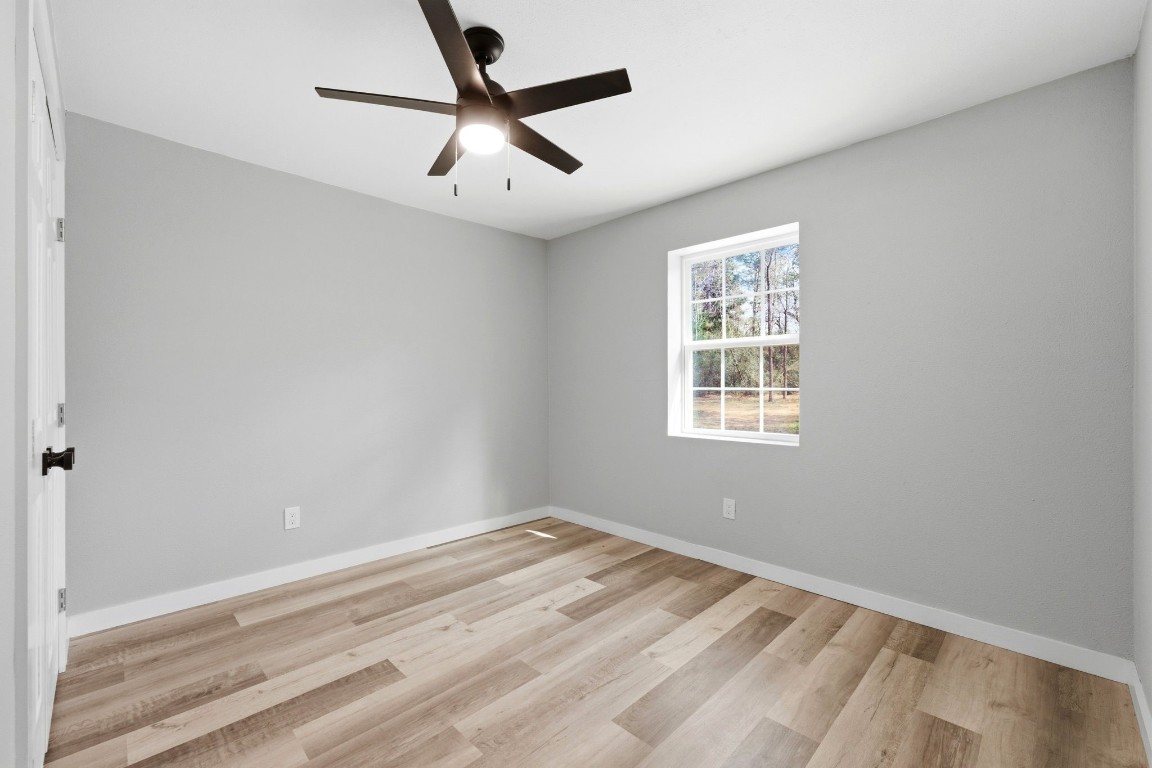 5222 Ranch Hill Drive Magnolia, TX 77354 - Photo 22 of 41 a view of a big room with wooden floor and windows