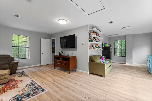 a bedroom with furniture and a flat screen tv
