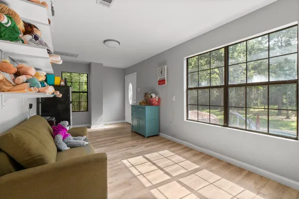 a living room with furniture and a floor to ceiling window