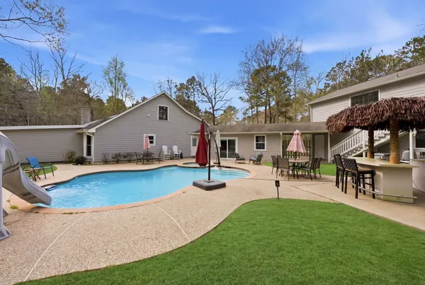 a view of a house with patio and a garden