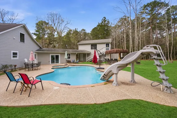 a view of a house with backyard sitting area and entertaining space