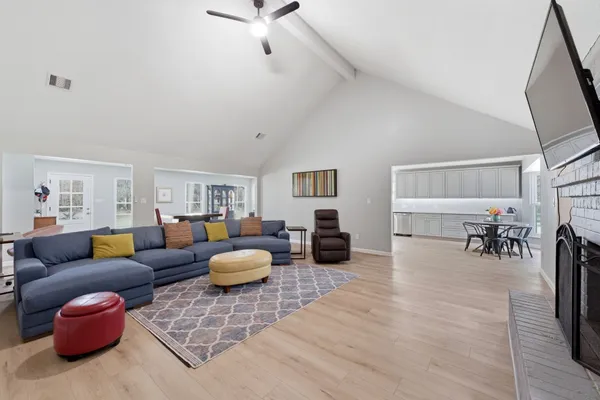 a living room with furniture and a wooden floor
