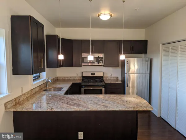 a kitchen with a refrigerator and a sink