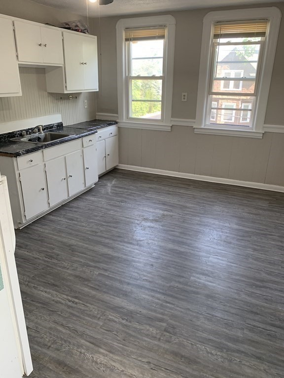 935 Liberty Street Springfield, MA 01104 - Photo 4 of 11 a kitchen with stainless steel appliances wooden floor and a window