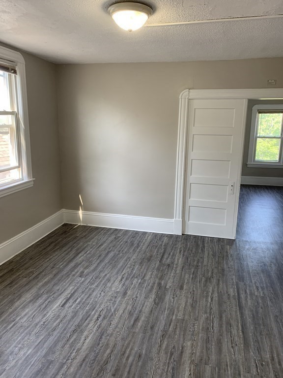 935 Liberty Street Springfield, MA 01104 - Photo 7 of 11 an empty room with wooden floor closet and windows