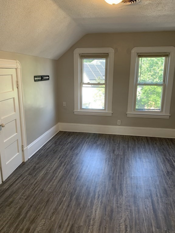 935 Liberty Street Springfield, MA 01104 - Photo 8 of 11 an empty room with wooden floor and windows