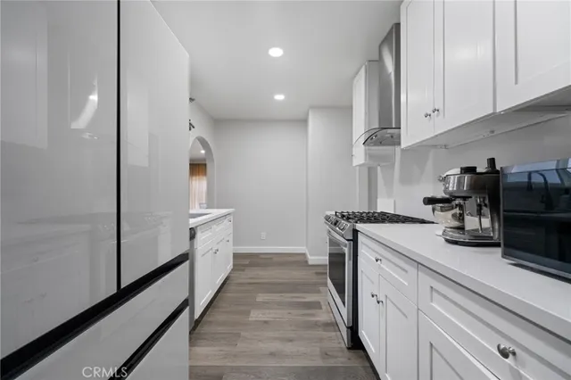 a kitchen with sink a stove and refrigerator