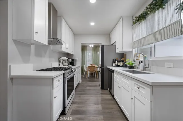 a kitchen with kitchen island granite countertop lots of counter top space and stainless steel appliances