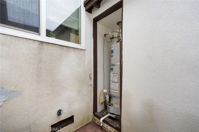 a front view of a house with a garden and trees