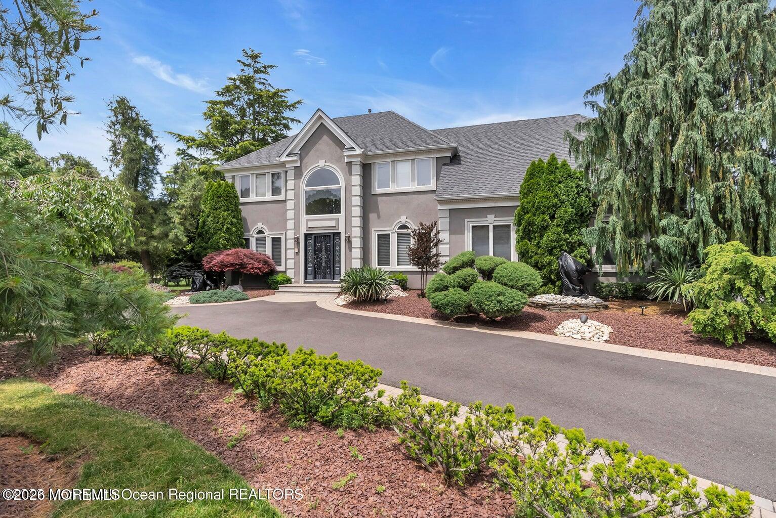 a front view of a house with a yard and a street