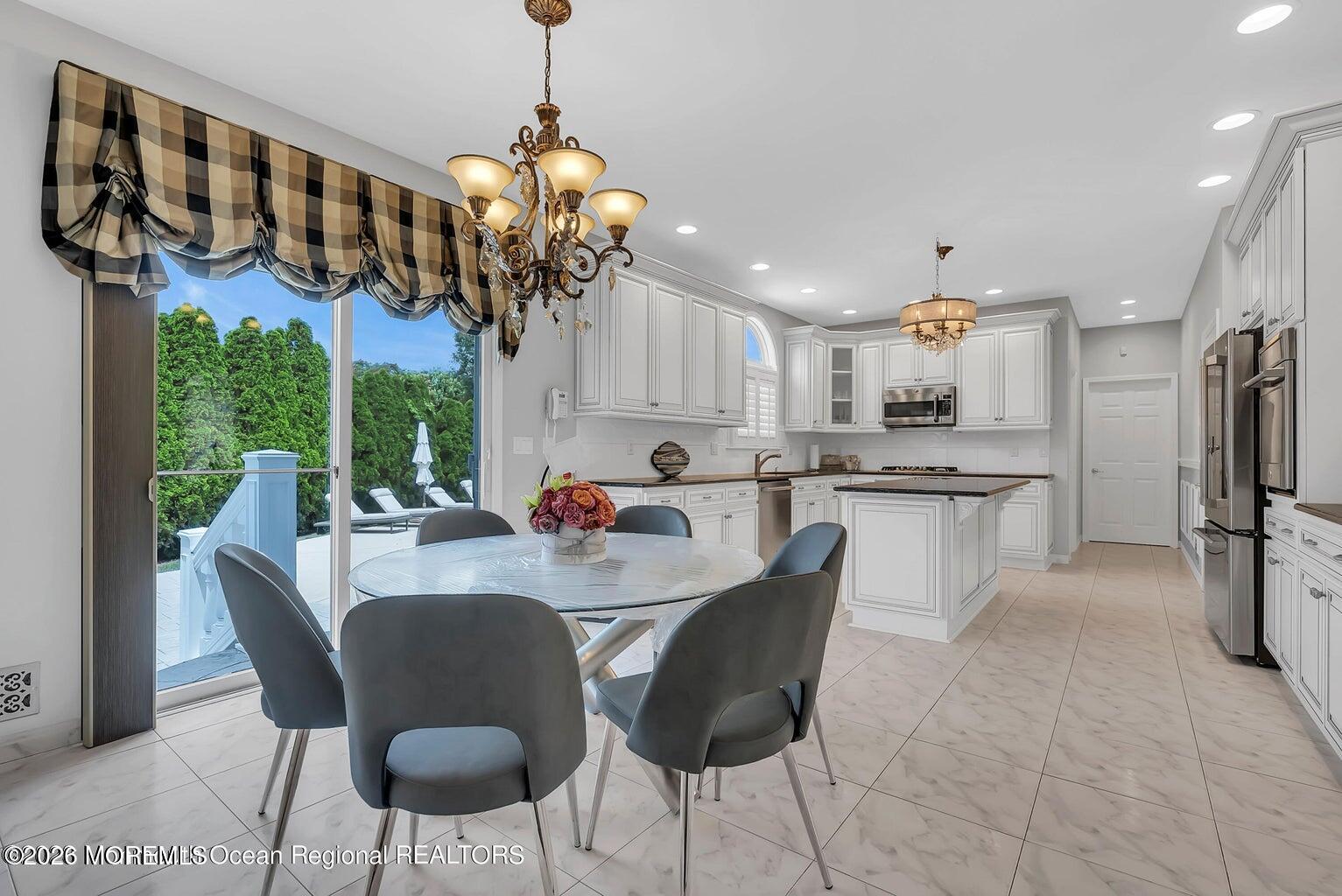 7 MacKenzie Road Eatontown, NJ 07724 - Photo 14 of 40 a view of a dining room with furniture a chandelier and window