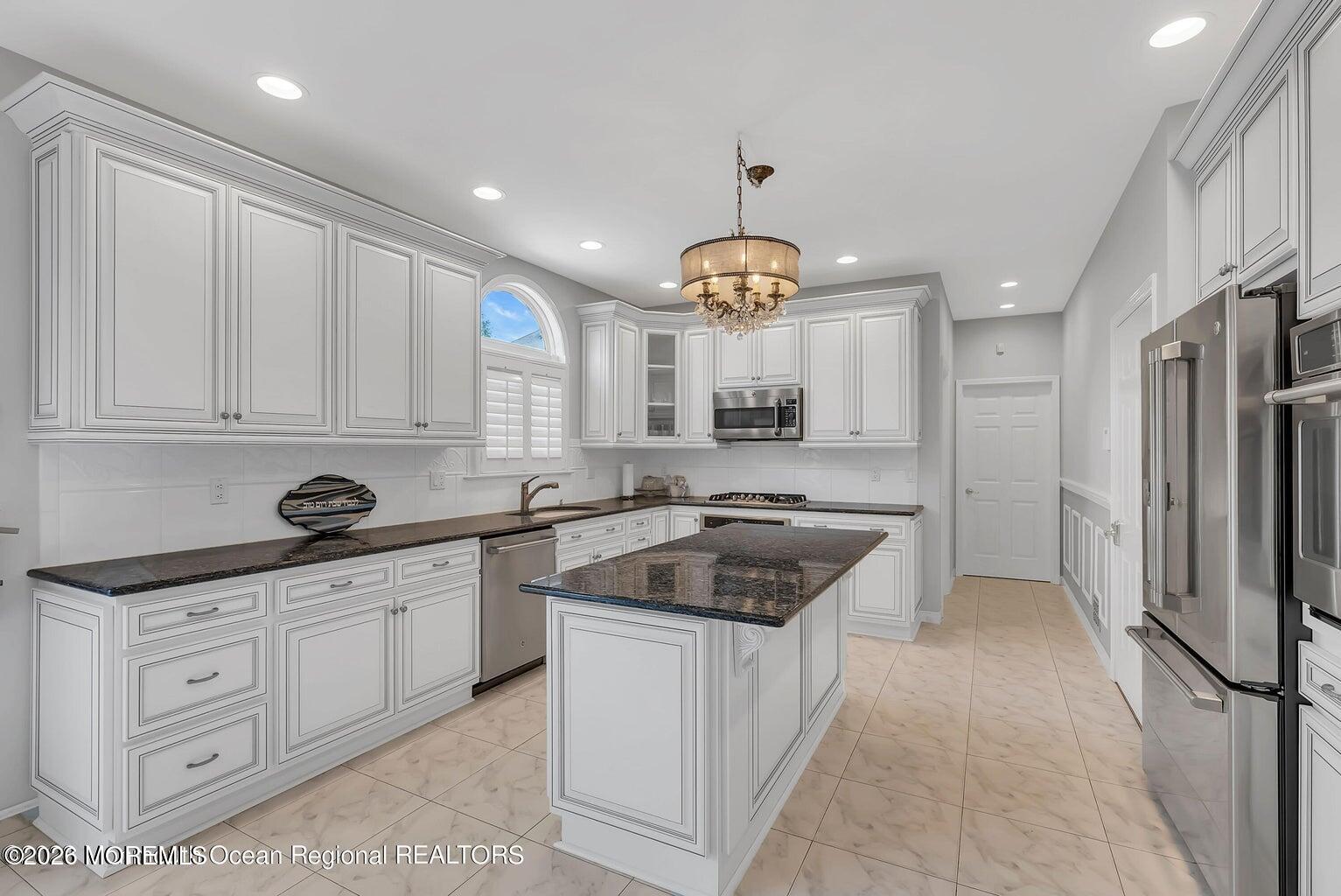 7 MacKenzie Road Eatontown, NJ 07724 - Photo 15 of 40 a kitchen with white cabinets and stainless steel appliances