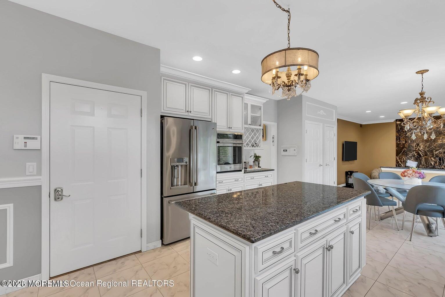 7 MacKenzie Road Eatontown, NJ 07724 - Photo 18 of 40 a kitchen with stainless steel appliances granite countertop a sink a refrigerator and a table