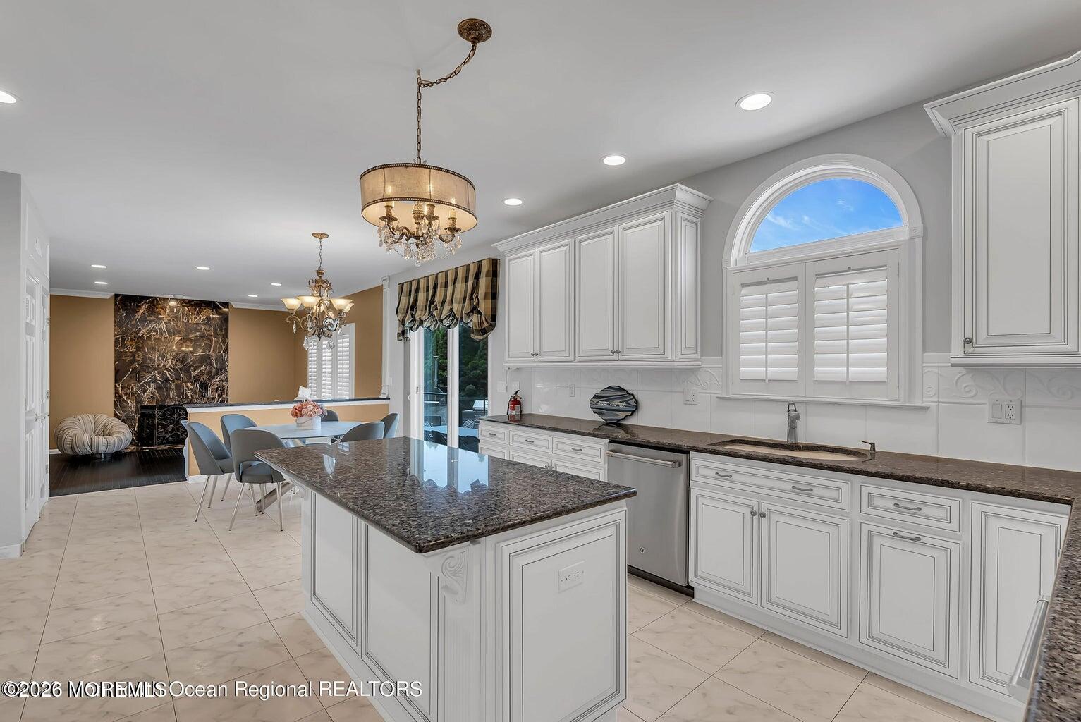 7 MacKenzie Road Eatontown, NJ 07724 - Photo 19 of 40 a kitchen with center island a sink appliances and a window