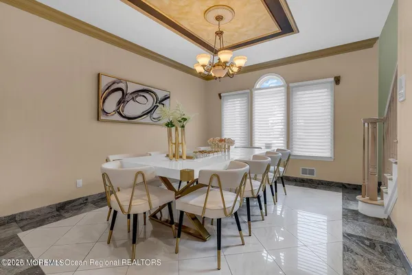 a view of a dining room with furniture and a chandelier
