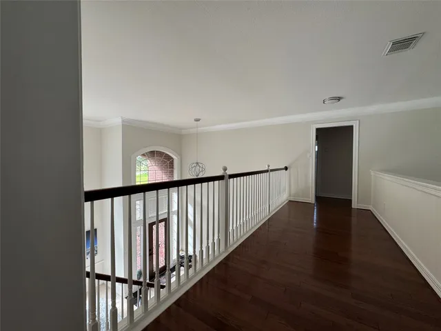 a view of staircase with railing and a window