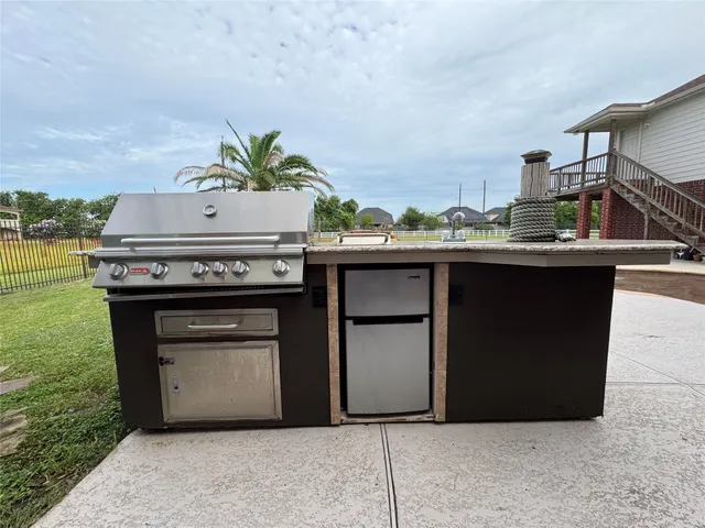 a stove top oven sitting inside of a kitchen