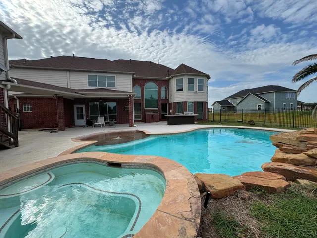 swimming pool with outdoor seating and yard