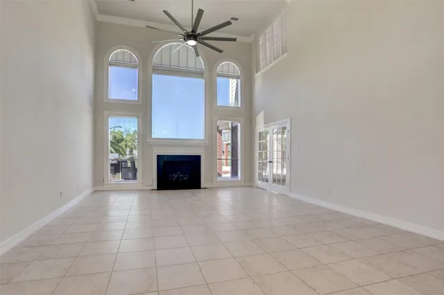 a view of an empty room with window and fireplace