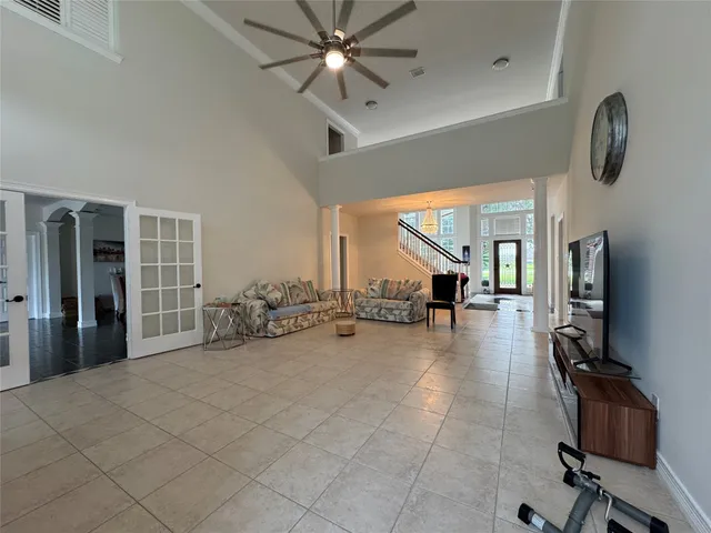 a gym room with gym equipment and a large window