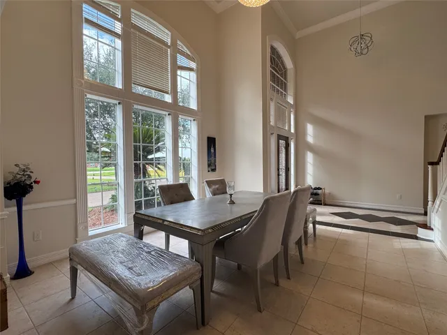 a dining room with furniture and a window