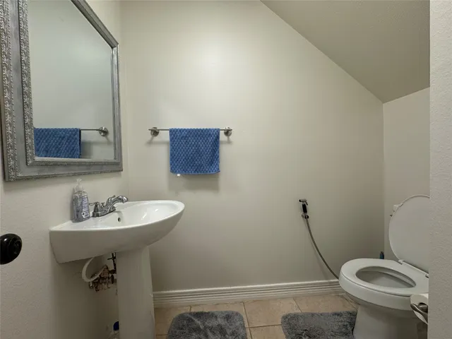 a bathroom with a sink a toilet and a mirror