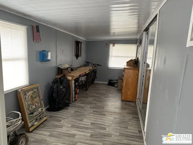 a very nice looking room with wooden floor and furniture