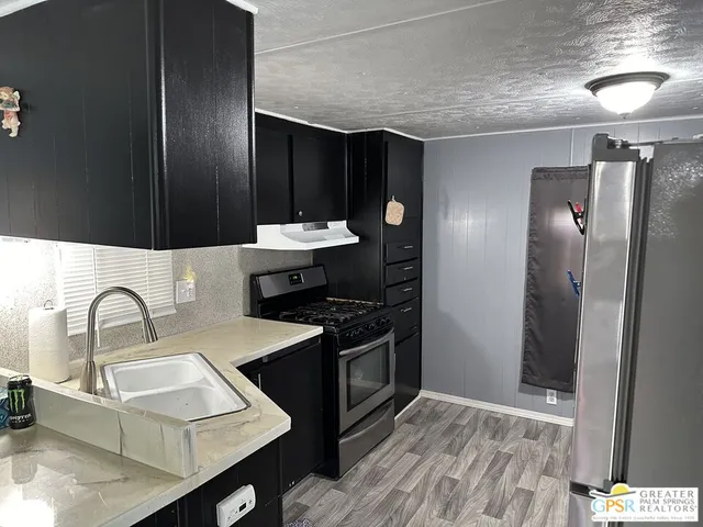 a kitchen with a sink and a refrigerator