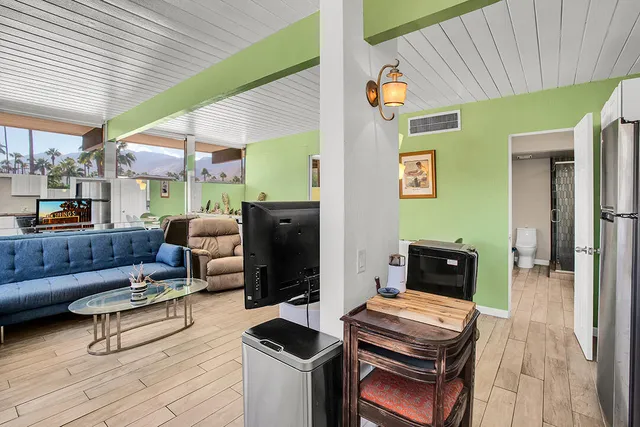 a living room with furniture and a kitchen view